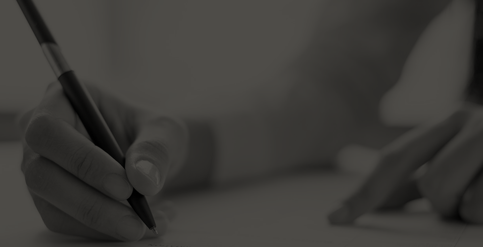 image of a pen in a person's hand